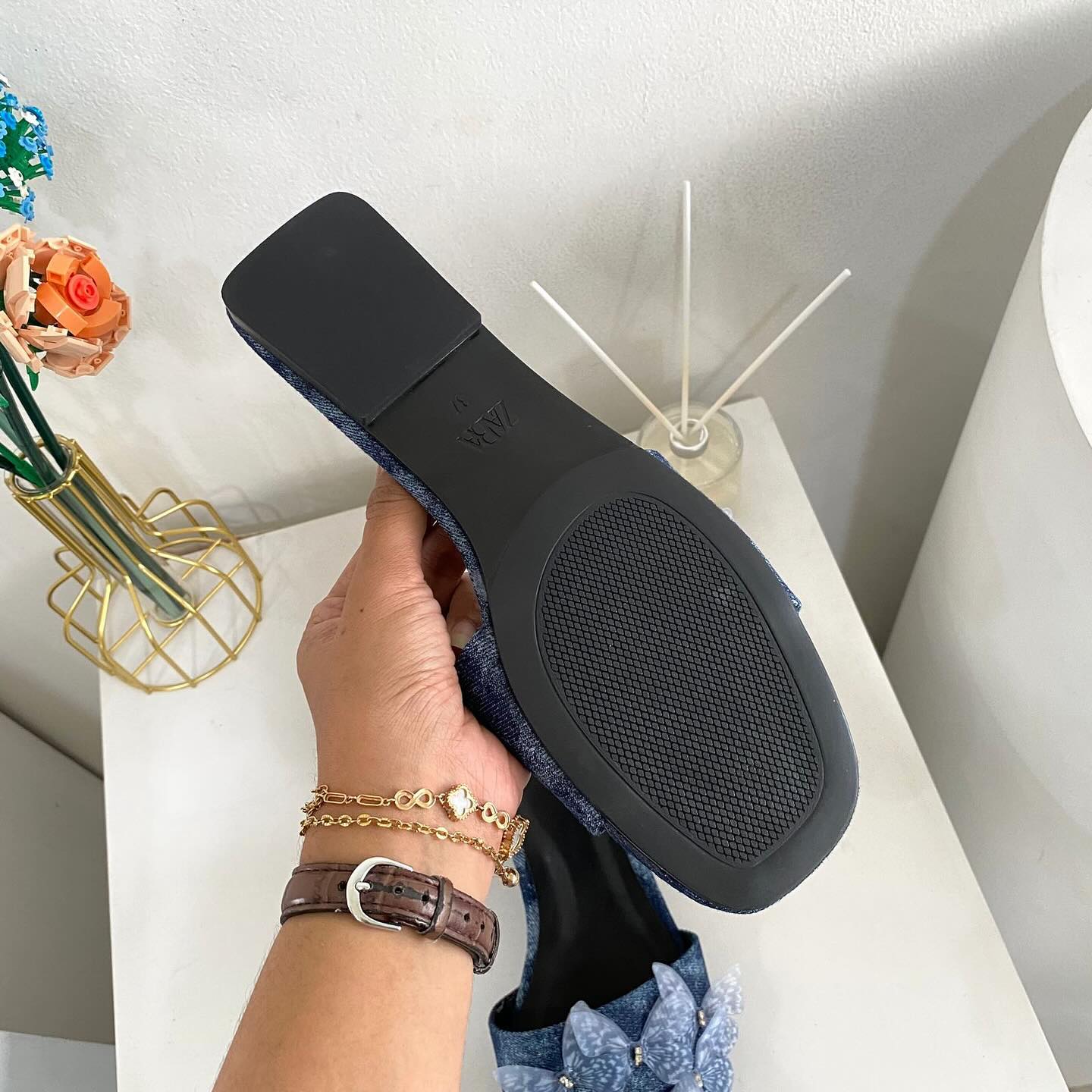 Flat denim sandals. Butterfly shaped embellishment at front